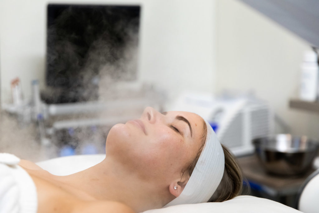 woman getting aesthetic treatment with steam
