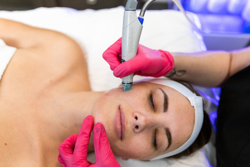 woman receiving a Hydrafacial in Rogers