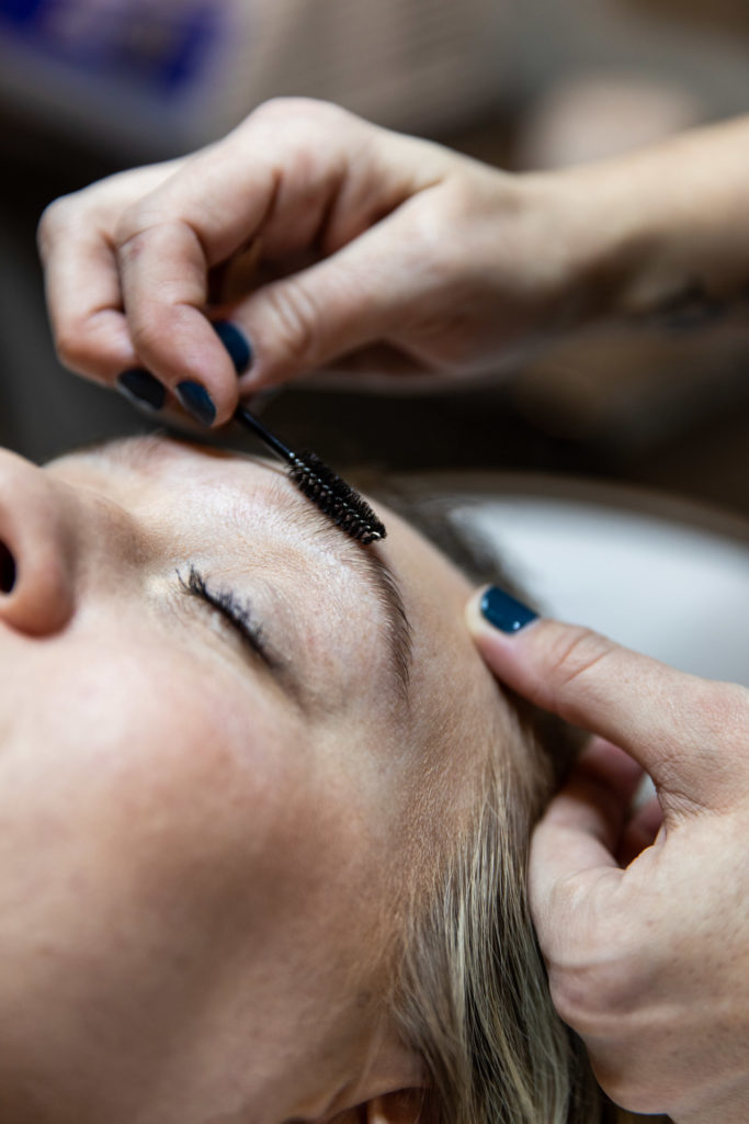 client receiving eyebrow aesthetic treatment