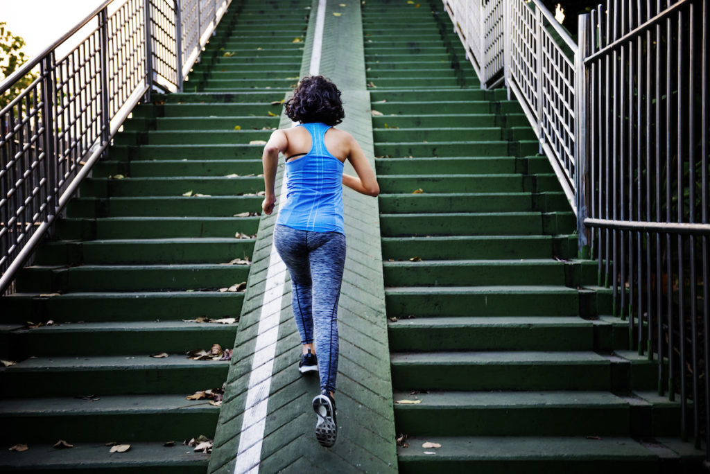 female jogging up stairs outdoors, excited by the best weight loss supplement in Arkansas