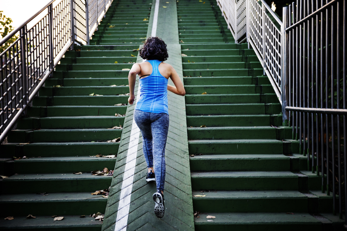 female jogging up stairs outdoors
