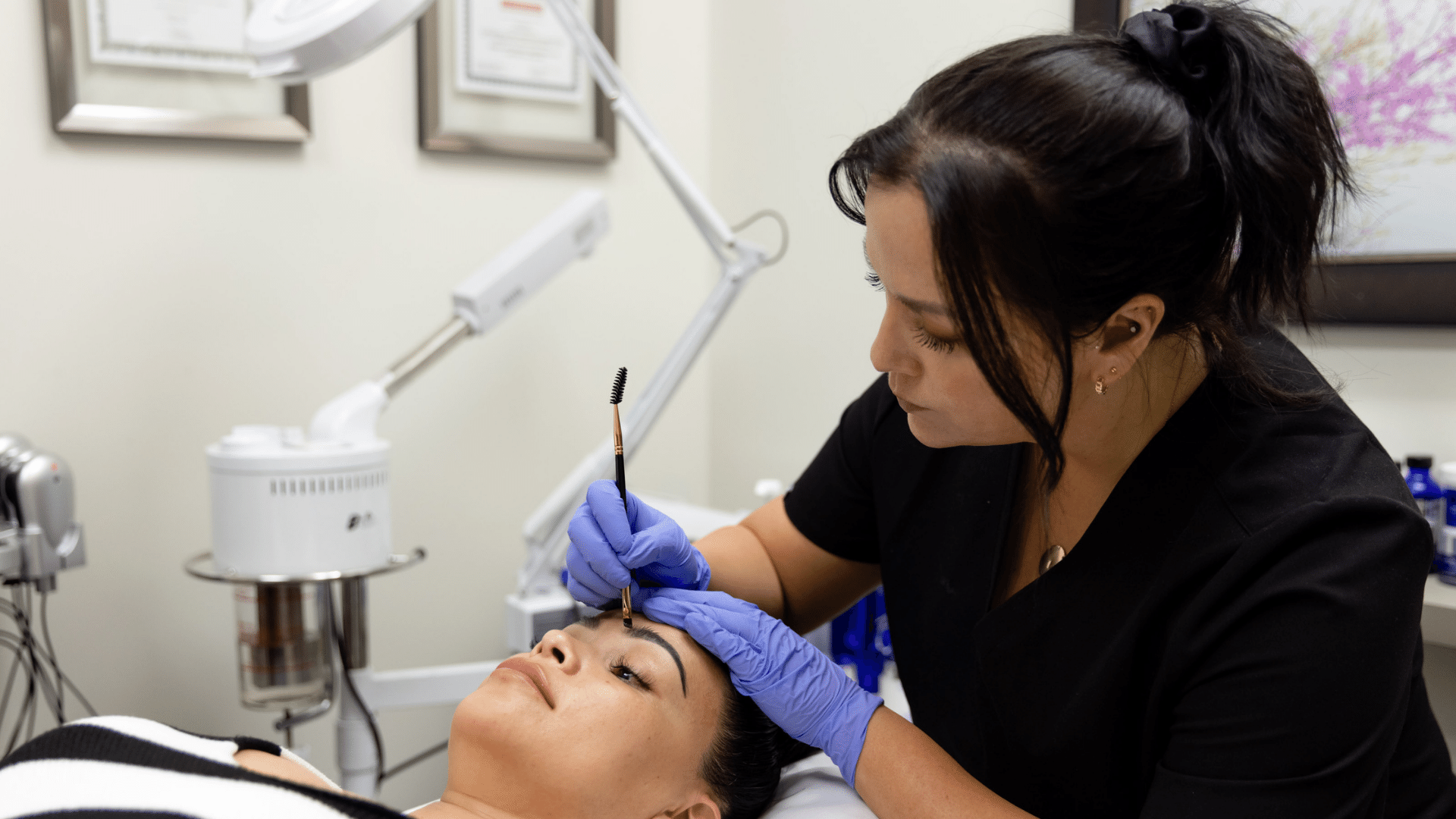Provider performing brow tinting on a client