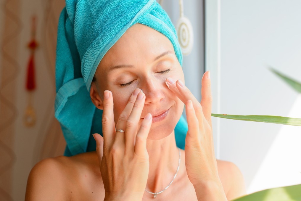 woman applying mature skin treatments